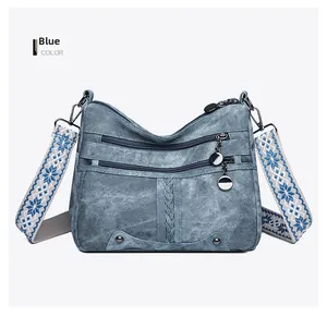 Blue retro soft faux leather bag with triple zippers and patterned woven shoulder strap