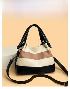 Detailed view of color-block tote bag with pebble leather texture and metal ring buckle