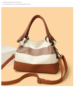 Detail of color-block tote showing lychee texture and gun-metal ring hardware