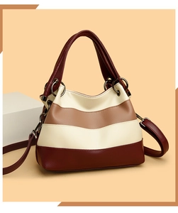 Detail of multi-color paneled leather tote with lychee texture and gunmetal hardware