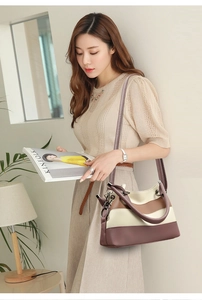 Close-up of tricolor patchwork leather bag with textured finish and dark hardware