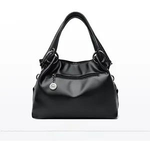 Detail view of the black lychee pattern leather handbag featuring a secure back zipper pocket