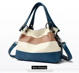 Detail view of large color-block shoulder bag in blue and beige textured faux leather