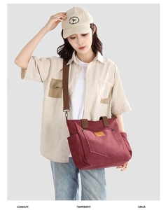 Detail of burgundy canvas tote bag featuring front pocket and kangaroo leather patch