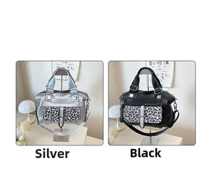 Detail of crocodile pattern leather bags with leopard print pockets in silver and black