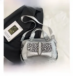 Silver crocodile textured handbag with leopard print flap and adjustable strap