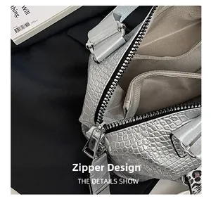 Close-up of the silver metallic crocodile texture handbag showing internal zipper pocket