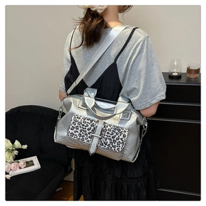 Model wearing the silver leopard print crossbody bag with crocodile texture details