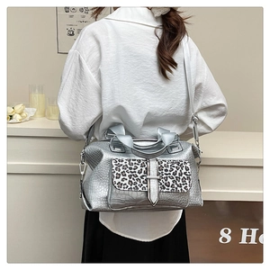 Detail showing silver crocodile-embossed texture and leopard print flap on shoulder bag