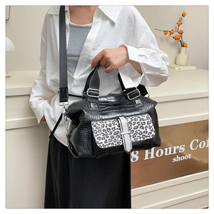Detail showing the leopard print pocket and crocodile texture on this crossbody handbag