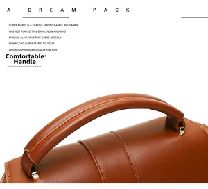Detail view of brown pebbled leather handbag featuring soft handle and gold hardware
