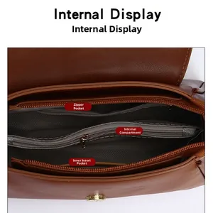 Internal display of brown leather handbag featuring a zipper pocket and V-pattern lining
