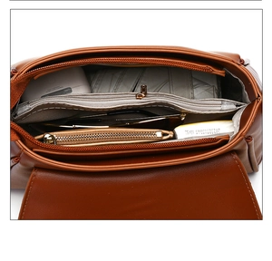 Top view of brown leather bag interior showing compartments and storage capacity