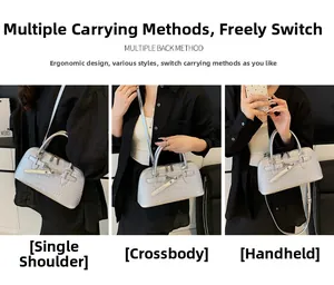 Silver crocodile embossed handbag featuring silver hardware and versatile strap options