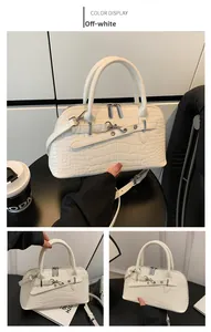 Detail of off-white crocodile embossed tote bag with silver hardware and adjustable strap