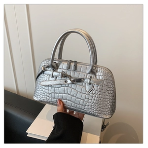 Silver crocodile embossed handbag showing metallic texture and detailed strap buckles
