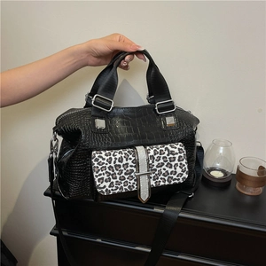 Fashionable black faux crocodile leather handbag with leopard print flap and wide strap
