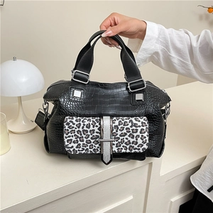 Chic black crocodile texture handbag with leopard print flap and silver metal buckle