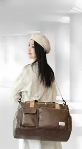 Macro shot of durable vintage brown leather texture and detailed pockets on travel bag