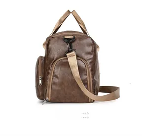 Side view of dark brown faux leather gym bag with adjustable strap and zip pocket