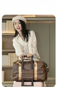 Brown retro travel bag with suitcase trolley sleeve and durable champagne woven handles