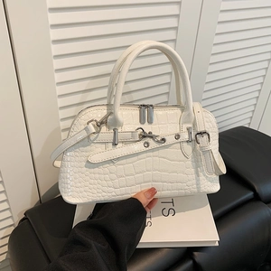 White crocodile embossed handbag with silver rivets and adjustable strap in modern style