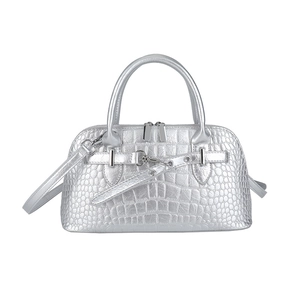Silver crocodile embossed handbag with dual handles and detachable shoulder strap on white base