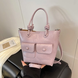 Chic lavender crocodile embossed tote bag with front utility pockets and knotted handle