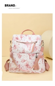 Detail shot of the butterfly print backpack with a stylish pink tassel pendant accessory