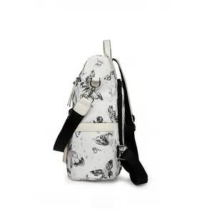 Side view detail of white butterfly print backpack with black adjustable shoulder straps