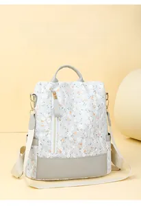Close-up of elegant floral fabric backpack with anti-theft zipper and grey leather detail