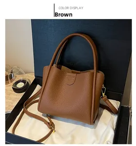 Détail du sac seau en cuir marron à motif litchi avec texte embossé Fashion Bags