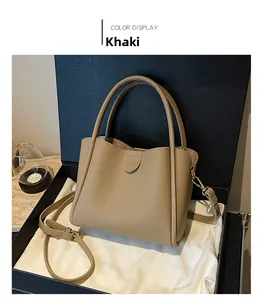 Vue détaillée d'un sac seau en cuir kaki présenté dans un coffret cadeau noir élégant