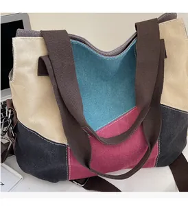 Close-up of color-block canvas tote bag with teal, pink, and grey patchwork details