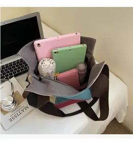 Interior shot of canvas tote bag showing large capacity for laptop and daily items