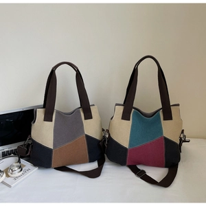Detail of color-block canvas tote bags with adjustable straps and textured handles