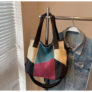 Detail of color-block canvas tote bag with adjustable shoulder strap and hand carry handles