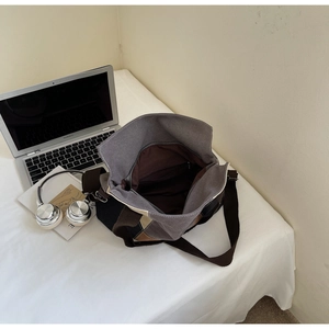 Top view of large canvas tote bag interior with zipper pocket and everyday laptop items