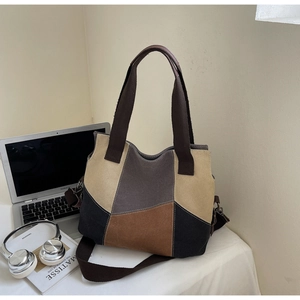 Detailed shot of multi-color patchwork canvas tote bag with adjustable shoulder strap