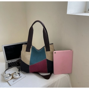Spacious canvas tote bag showing interior capacity for laptops and headphones
