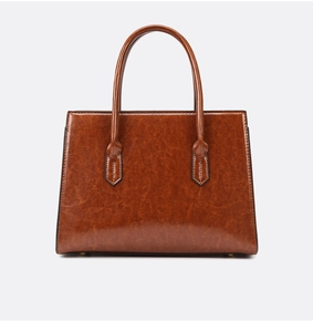 Detail of caramel oil wax leather tote with retro texture and sturdy dual handles