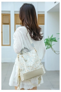 Close-up of casual women's backpack with delicate white lace and orange floral patterns