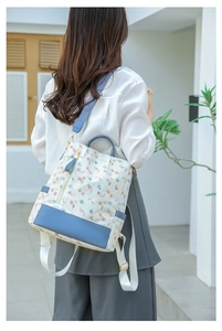 Floral print backpack for women with leather trim and adjustable blue straps