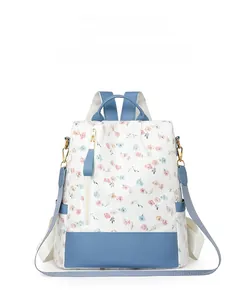 Close-up of floral pattern and sky blue leather trim on women's large backpack