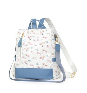 Floral print backpack with light blue leather trim and adjustable shoulder straps detail