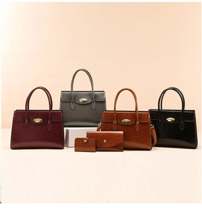 Detailed set of four vintage leather tote bags in burgundy, grey, tan, and black colors