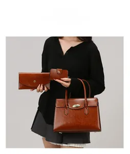 Three-piece brown oil leather handbag set featuring elegant gold twist lock detail