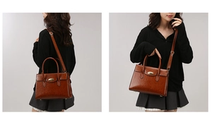 Detail of a brown leather handbag with gold oval twist lock and adjustable shoulder strap