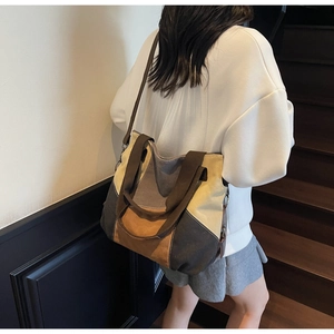 Detail of multi-color canvas tote bag showing textured stitching and adjustable strap