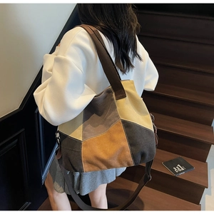 Detail view of large canvas tote bag with brown patchwork design and adjustable strap